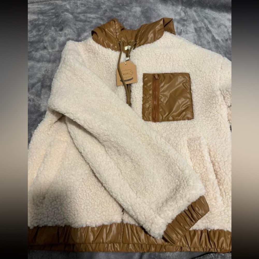 Windbreaker material with sherpa material on the outside!